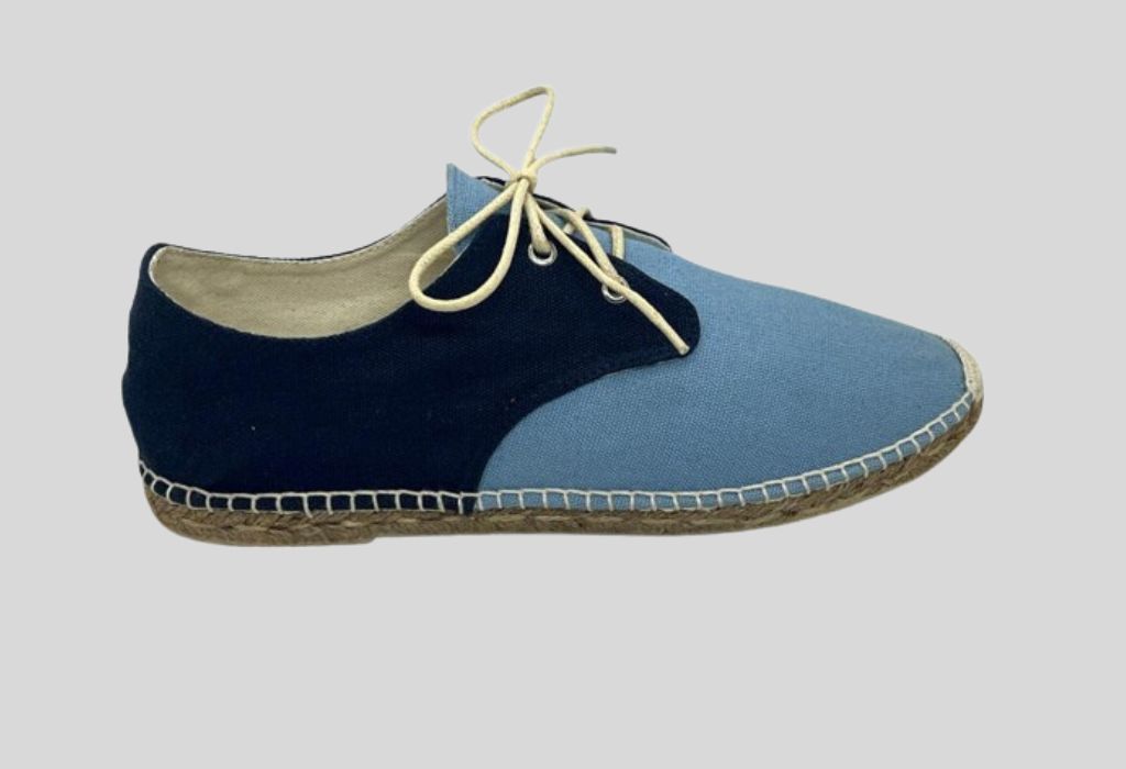 A blue casual lace-up shoe with a beige inner lining and a tan sole.