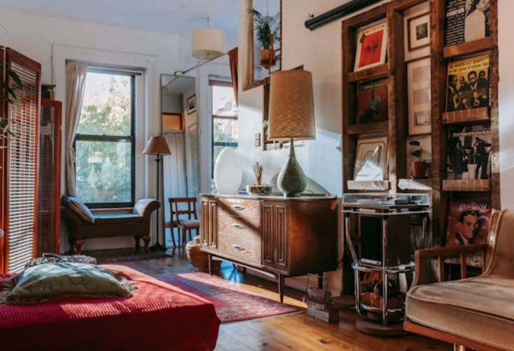 Cozy room with vintage furniture, artworks on the wall, and a warm sunlight ambiance.